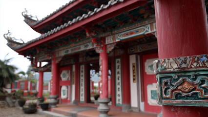 Fototapeta premium Traditional red colour Chinese temple building, red pillar, wooden door, roof tiles, sacred praying place.