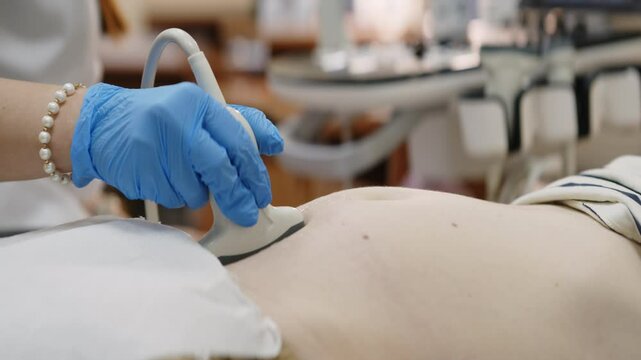 Medical worker performing ultrasound scan on pregnant woman in clinic. Concept: prenatal diagnostics and maternal care