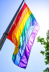 Colorful pride flags displayed among trees during a vibrant celebration of diversity and inclusion...
