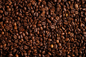 Roasted coffee beans close-up texture background
