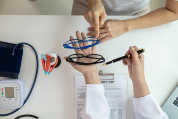The ophthalmologist lets the patient choose the eyeglass frames that fit their face and sends them...