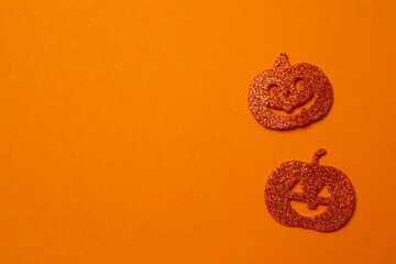 Halloween concept. Halloween festive background design featuring orange decorative pumpkins. Top view, space for text