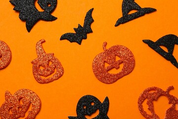 Halloween festive background design featuring pumpkins, ghosts and decorative witch hats. Top view