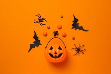 Halloween festive background design featuring pumpkin basket, bats and spiders. Happy Halloween holiday concept