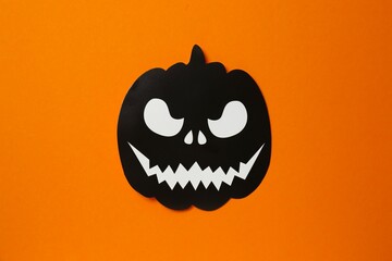 Halloween festive background design featuring black decorative pumpkin. Top view