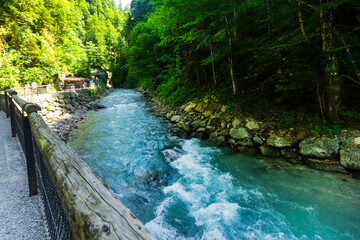 A mountain river with clear, turquoise, clear water, with a rocky bed and shores in Bavaria