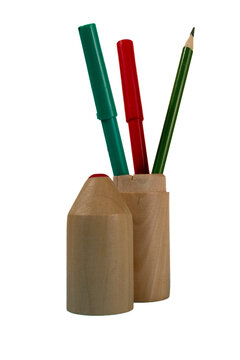Pencils and a marker placed in a wooden holder on a clean white background