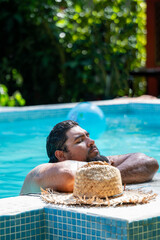 Costa Rican tourist enjoying his vacation by the pool relaxing in the town of Tortuguero, Costa Rica.