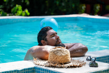 Costa Rican tourist enjoying his vacation by the pool relaxing in the town of Tortuguero, Costa Rica