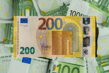 Close-Up of a 200 Euro Spread on a Background of 100 Euro Banknotes