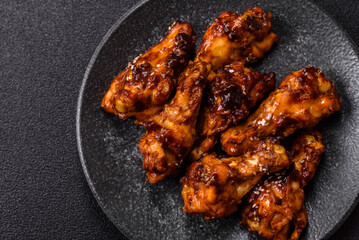 Grilled or barbecued chicken wings with teriyaki sauce, spices and sesame seeds. Teriyaki chicken
