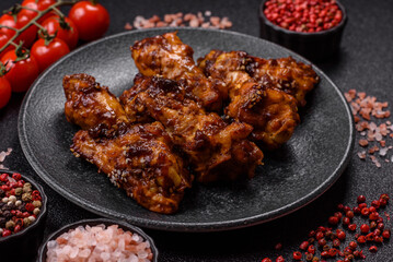 Grilled or barbecued chicken wings with teriyaki sauce, spices and sesame seeds. Teriyaki chicken
