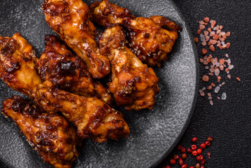 Grilled or barbecued chicken wings with teriyaki sauce, spices and sesame seeds. Teriyaki chicken