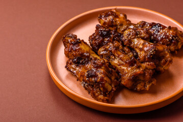 Grilled or barbecued chicken wings with teriyaki sauce, spices and sesame seeds. Teriyaki chicken