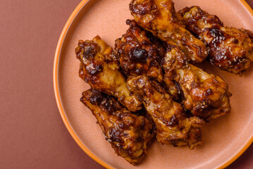 Grilled or barbecued chicken wings with teriyaki sauce, spices and sesame seeds. Teriyaki chicken