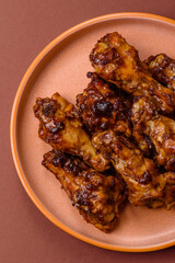 Grilled or barbecued chicken wings with teriyaki sauce, spices and sesame seeds. Teriyaki chicken