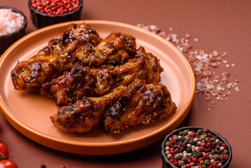 Grilled or barbecued chicken wings with teriyaki sauce, spices and sesame seeds. Teriyaki chicken