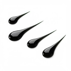 Four glossy black drops with elongated pointed tails arranged diagonally on a clean white background