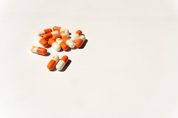 pills on white background, symbolizing medication, health care, treatment, or pharmaceutical use