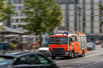 Fire truck in motion. Emergency vehicle on street. Dynamic city scene