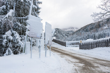 A snowy road with a sign that says "Do not enter."