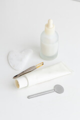 Minimal Skincare Flat Lay with Dropper Bottle and Face Tools