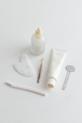Minimal Skincare Flat Lay with Dropper Bottle and Face Tools
