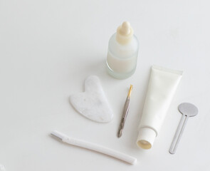 Minimal Skincare Flat Lay with Dropper Bottle and Face Tools