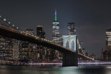 Scenic night view of Brooklyn Bridge with the distinctive Manhattan Skyline in the background