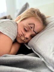Peaceful adorable baby sleeping on a bed at home.
