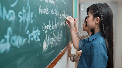 Skilled asian girl writing engineering prompt and programing system while standing blackboard with generated AI prompt written by diverse smart student at STEM technology lesson. Education. Pedagogy. - Powered by Adobe