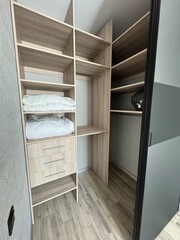 Modern Walk-In Closet with Built-In Wooden Shelving