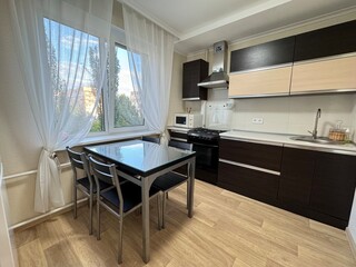Cozy Kitchen Interior with Large Window and Modern Cabinets