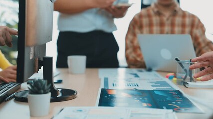 A business team engages in a brainstorming session in a modern office setting, utilizing laptops and tablets for collaborative discussions on innovative strategies. SACTR