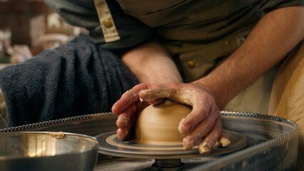 Master potter in studio male craftsman sculpting vase jug clay art unrecognizable man human hands...