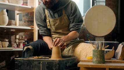 Caucasian man male working creating new clay product in studio workshop small business hobby...