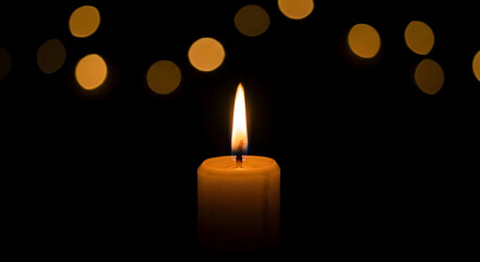 burning candle on a dark background