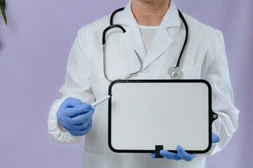 An elderly doctor holds a clean marker board in his hands.