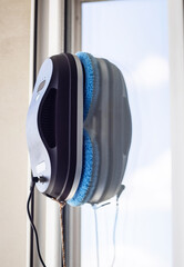 Robot washer washes window, window cleaning process with modern household appliances