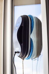 Robot washer washes window, window cleaning process with modern household appliances