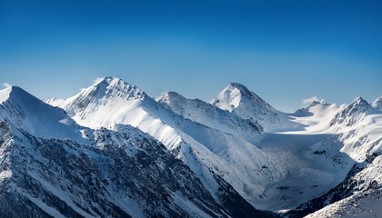 Obraz premium vast winter mountain landscape under clear blue sky with snow covered peaks