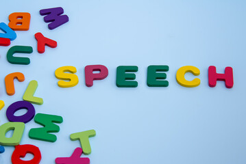 A speech word on a blue background was formed from a multitude of disparate Latin alphabetic letters.