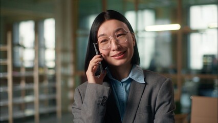 Asian businesswoman smiling talking mobile phone Chinese woman business entrepreneur manager...