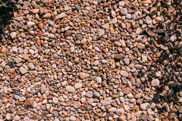 The texture of small pebbles in the garden. Garden paths made of small pebbles. Close-up