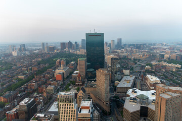 Boston skyline with skyscrapers and buildings under a hazy sky.
