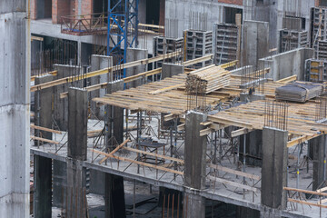 Naklejka premium Construction crane on Housing. Construction site with buildings under construction. Tower cranes in action. Crane during formworks. Multi Storey Residential Buildings construction, aerial view.