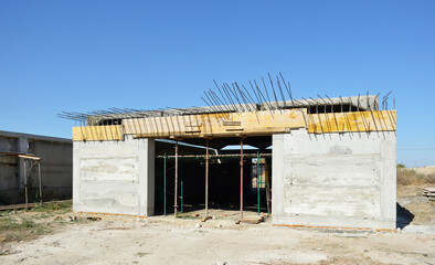 construction of a new garage. the building is missing a gate and a roof. construction industry and...