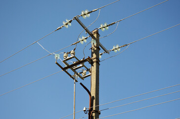 concrete power line pillar, with wires, against the sky. Wires are strung on iron pylons. delivery...