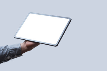 Close-up of a tablet with a blank white screen held in a man's hand against a neutral background....