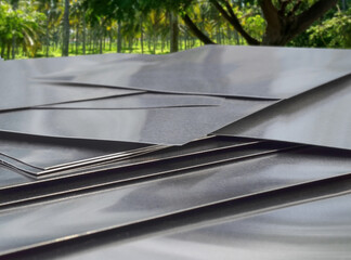 stack of thick aluminum metal square pieces. small sheets in the cool outdoors
